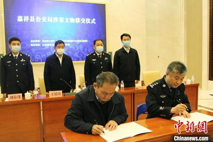 山東博物館館長(zhǎng)鄭同修和嘉祥縣人民政府副縣長(zhǎng)、公安局局長(zhǎng)趙健簽署移交協(xié)議?！≮w曉 攝