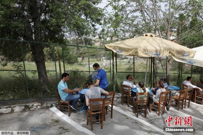 資料圖：希臘雅典，人們在一家露天咖啡享用飲品。