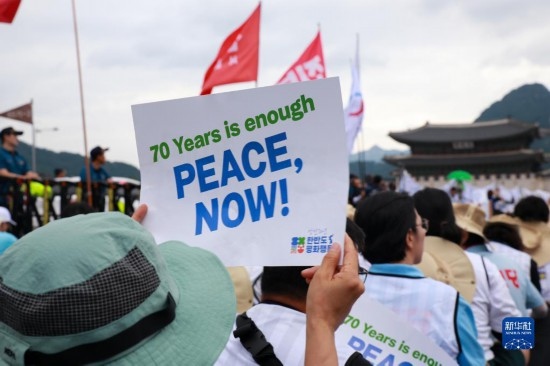7月22日，在韓國首爾，人們手舉標(biāo)語參與反戰(zhàn)游行。新華社發(fā)（楊暢 攝）