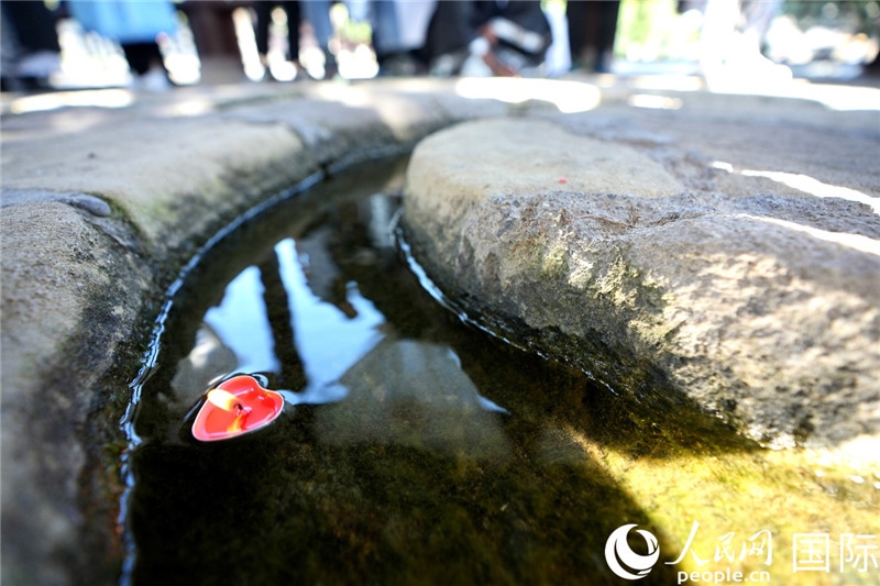 圖為水渠里流過的“桃心”蠟燭。人民網(wǎng) 盧鵬宇攝