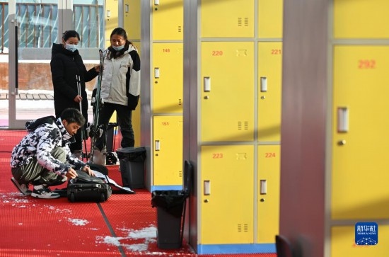 12月21日，游客在滑雪服務(wù)大廳整理滑雪裝備。