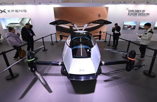 2023年12月1日，在鏈博會智能汽車鏈展區(qū)小鵬汽車展臺，參觀者觀看一臺智能飛行器。新華社記者蔡湘鑫攝