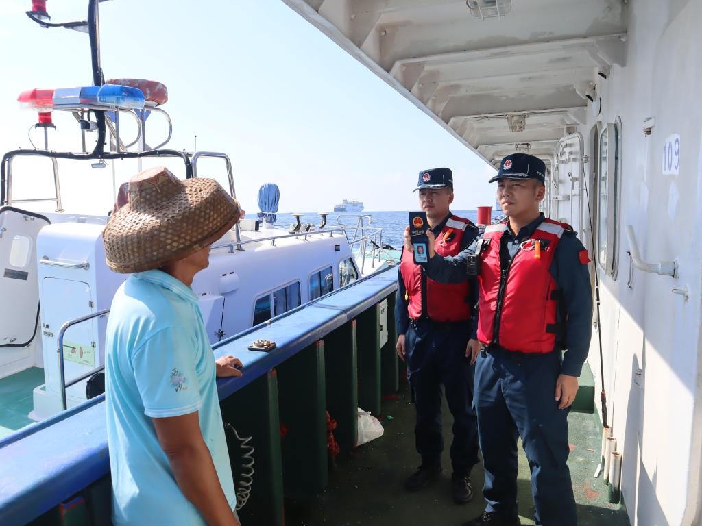 圖為5月12日海警執(zhí)法員登臨檢查漁船。（中國(guó)海警局南海分局供圖）