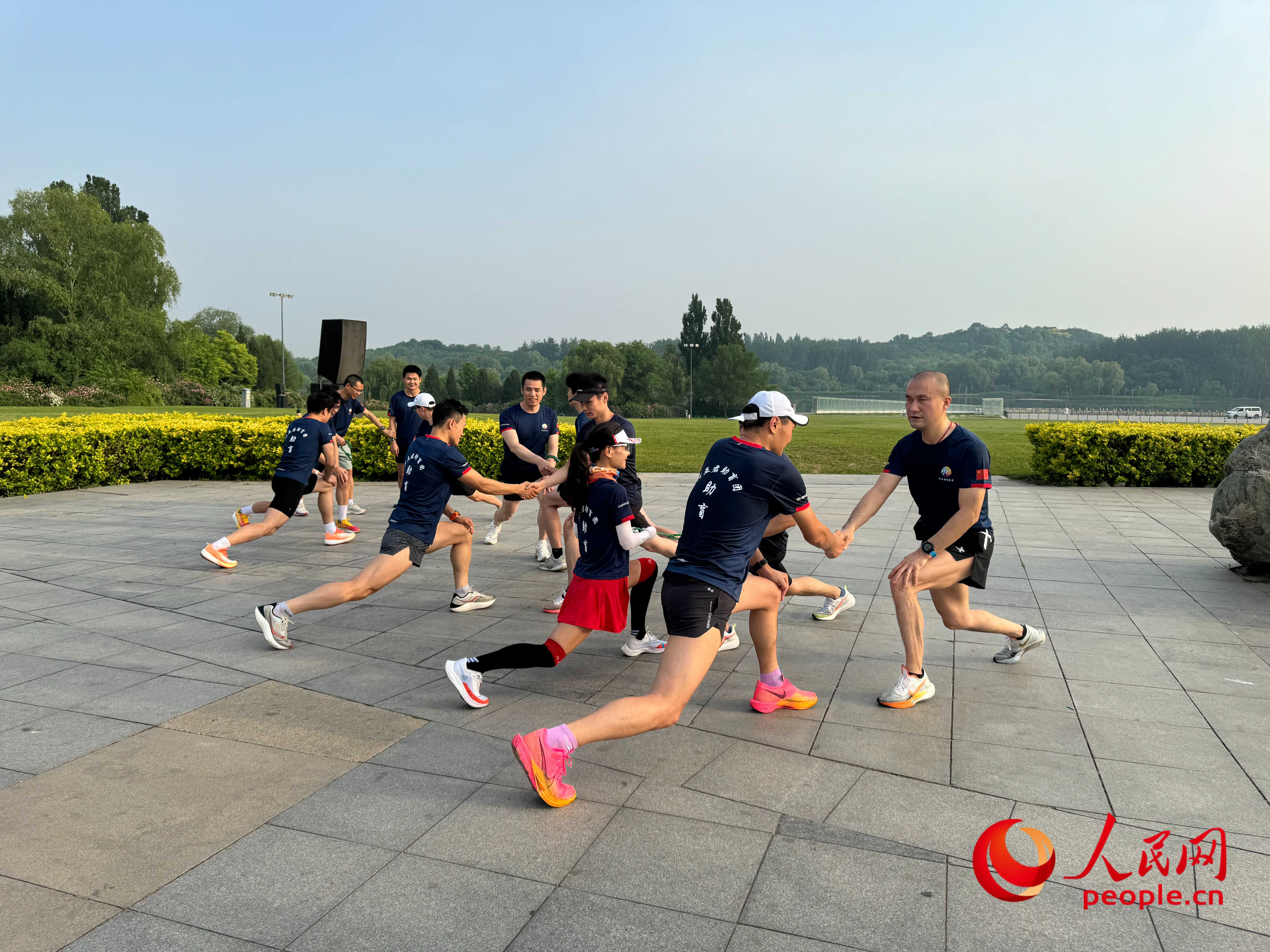 盲人和志愿者做跑步前準(zhǔn)備。人民網(wǎng) 周靜圓攝