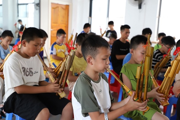 孩子們在學吹蘆笙。融水縣文化館供圖