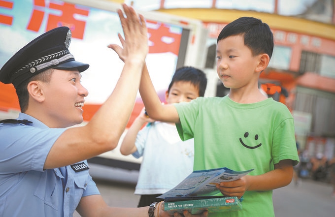 ▲7月10日，江西省吉安市公安局吉州分局組織民警深入轄區(qū)開(kāi)展安全宣傳，民警向小朋友講解防溺水知識(shí)。朱文杰攝