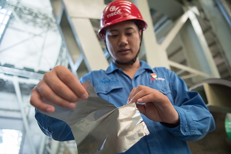 2018年8月8日，山西省太原市，太鋼不銹鋼精密帶鋼有限公司工作人員用手撕開不銹鋼。