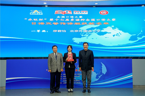中國(guó)翻譯協(xié)會(huì)副會(huì)長(zhǎng)中國(guó)外文局中東歐與中南亞傳播中心（人民畫報(bào)社）主任姜永鋼（右一）、原中國(guó)教育工會(huì)全國(guó)委員會(huì)巡視員白立文（左一）為獲得日語(yǔ)交傳組一等獎(jiǎng)的北京外國(guó)語(yǔ)大學(xué)廖君怡頒獎(jiǎng)（主辦方提供）